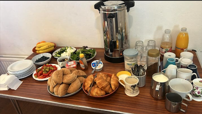 Women sharing food and conversation at a community table